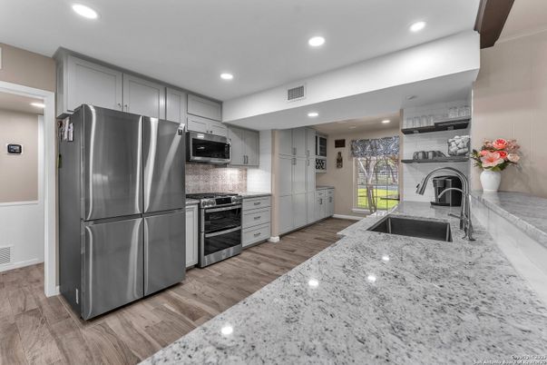 Fireplace, Interior, Kitchen, Recessed Lighting, Stainless Steel Appliances, Washer, Wood Texture Flooring