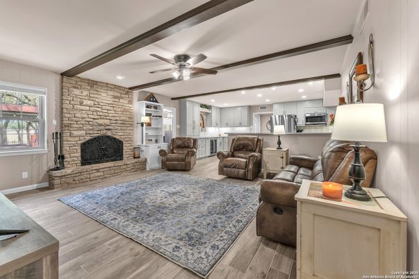 Fireplace, Interior, Kitchen, Living room, Recessed Lighting, Stainless Steel Appliances, Stone Walls, Wood Texture Flooring