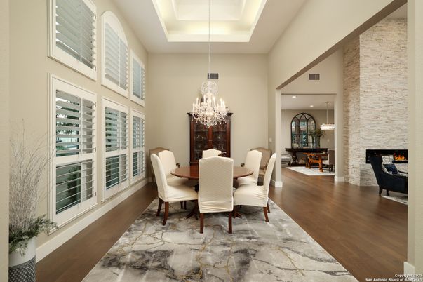 Chandelier, Dining room, Fireplace, Interior, Pendant Lights, Recessed Lighting, Stone Walls, Wood Texture Flooring