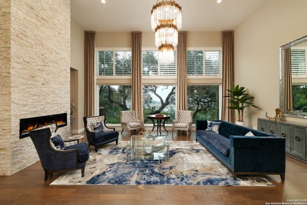 Chandelier, Fireplace, Interior, Living room, Recessed Lighting, Stone Walls, Wood Texture Flooring