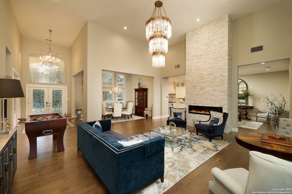 Billiard Table, Chandelier, Dining room, Fireplace, Game Room, Interior, Living room, Pendant Lights, Recessed Lighting, Wood Texture Flooring