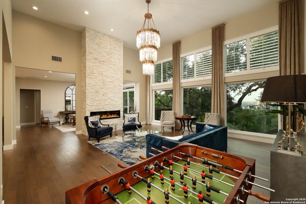 Chandelier, Fireplace, Game Room, Interior, Living room, Recessed Lighting, Wood Texture Flooring