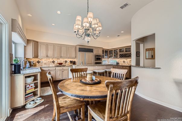 Chandelier, Dining room, Interior, Kitchen, Recessed Lighting, Stainless Steel Appliances, Wood Texture Flooring