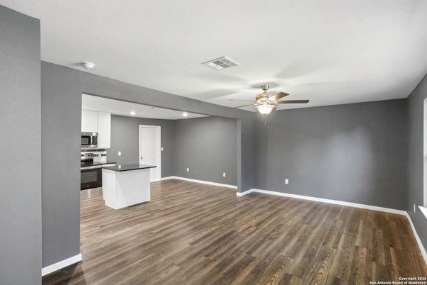 Empty room, Interior, Kitchen, Recessed Lighting, Stainless Steel Appliances, Wood Texture Flooring