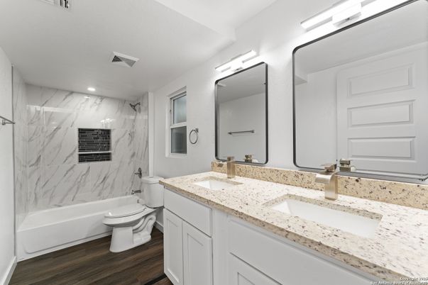 Bathroom, Dual Sink Vanities, Interior, Marble Walls, Recessed Lighting, Wood Texture Flooring