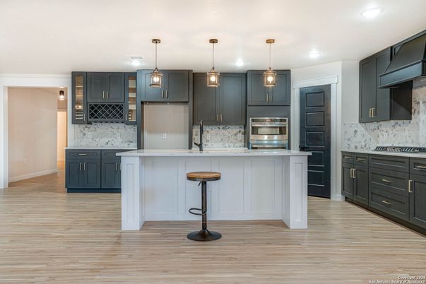 Interior, Kitchen, Marble Walls, Pendant Lights, Recessed Lighting, Stainless Steel Appliances, Wood Texture Flooring