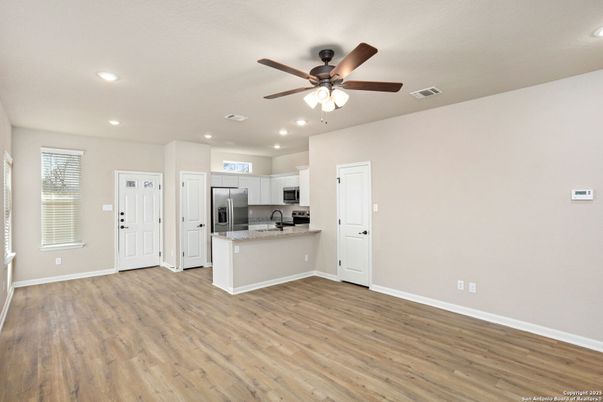 Empty room, Interior, Kitchen, Recessed Lighting, Stainless Steel Appliances, Wood Texture Flooring