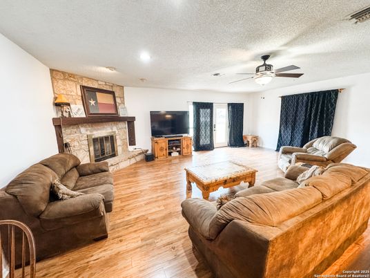 Fireplace, Interior, Living room, Recessed Lighting, Stone Walls, Wood Texture Flooring