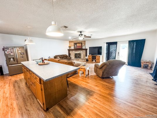 Fireplace, Interior, Kitchen, Living room, Pendant Lights, Stone Walls, Wood Texture Flooring