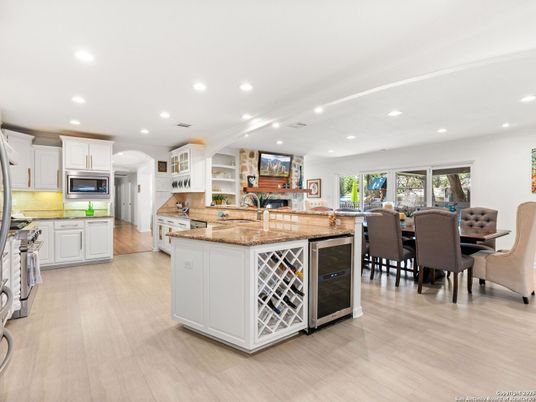 Dining room, Fireplace, Interior, Kitchen, Recessed Lighting, Stainless Steel Appliances, Wood Texture Flooring
