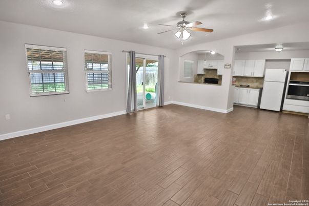 Empty room, Interior, Kitchen, Recessed Lighting, Stainless Steel Appliances, Wood Texture Flooring