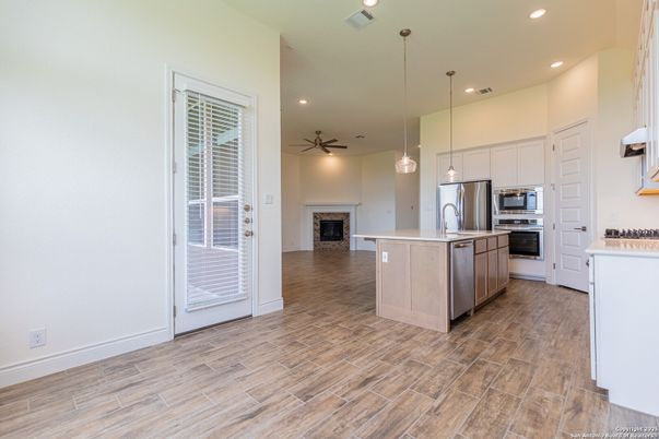 Fireplace, Interior, Kitchen, Pendant Lights, Recessed Lighting, Stainless Steel Appliances, Wood Texture Flooring