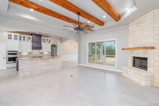 Fireplace, Interior, Kitchen, Pendant Lights, Recessed Lighting, Stainless Steel Appliances, Stone Walls, Wooden Beams