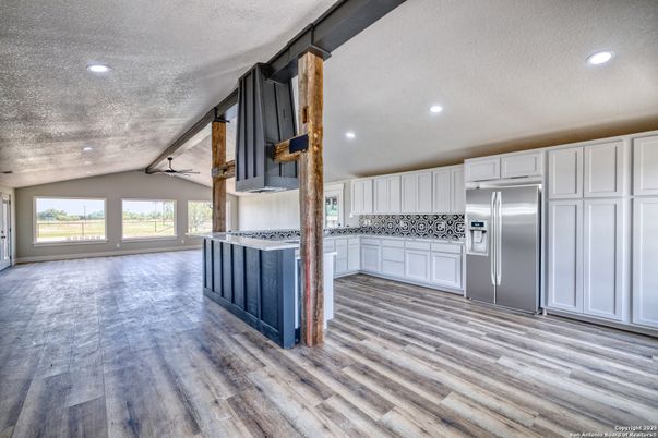 Empty room, Interior, Kitchen, Recessed Lighting, Stainless Steel Appliances, Wood Texture Flooring