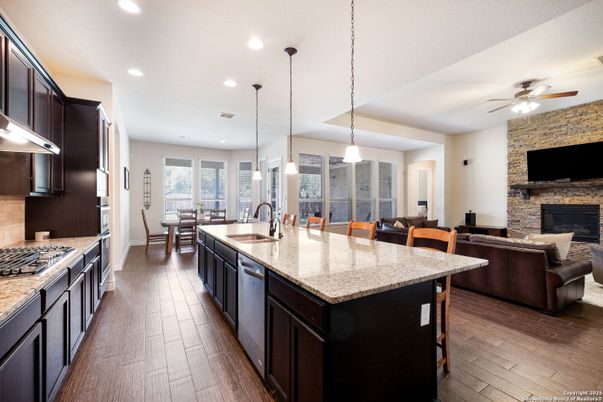 Dining room, Fireplace, Interior, Kitchen, Pendant Lights, Recessed Lighting, Stainless Steel Appliances, Stone Walls, Wood Texture Flooring