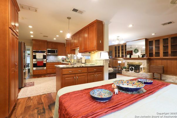 Fireplace, Interior, Kitchen, Pendant Lights, Recessed Lighting, Stainless Steel Appliances, Wood Texture Flooring