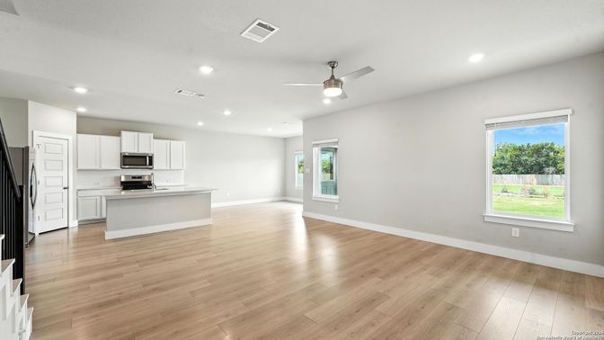Empty room, Interior, Kitchen, Recessed Lighting, Stainless Steel Appliances, Wood Texture Flooring
