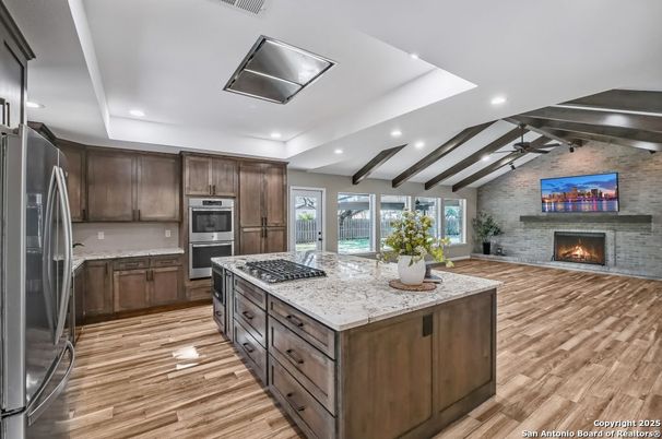 Fireplace, Interior, Kitchen, Recessed Lighting, Stainless Steel Appliances, Stone Walls, Wooden Beams, Wood Texture Flooring