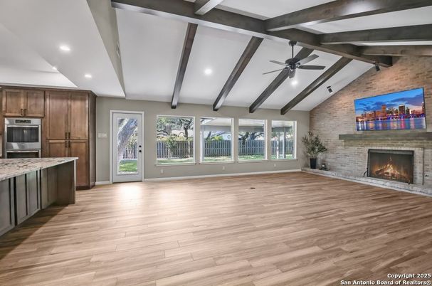 Empty room, Fireplace, Interior, Kitchen, Recessed Lighting, Stone Walls, Wooden Beams, Wood Texture Flooring