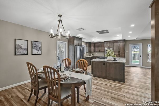 Chandelier, Dining room, Interior, Kitchen, Pendant Lights, Recessed Lighting, Stainless Steel Appliances, Wood Texture Flooring