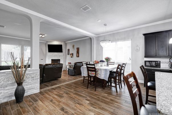 Chandelier, Dining room, Fireplace, Interior, Living room, Pendant Lights, Recessed Lighting, Wood Texture Flooring