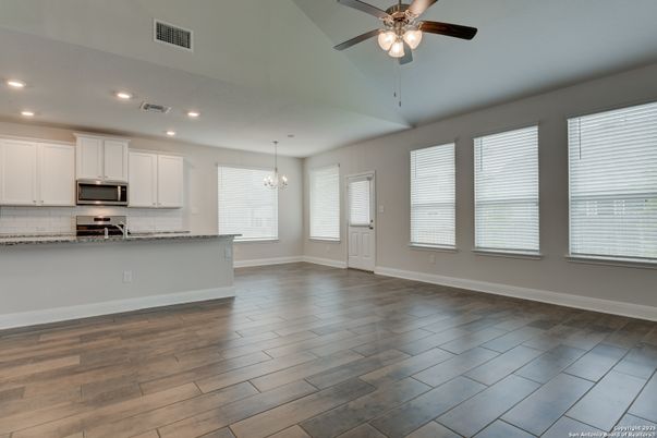 Chandelier, Empty room, Interior, Kitchen, Recessed Lighting, Stainless Steel Appliances, Wood Texture Flooring