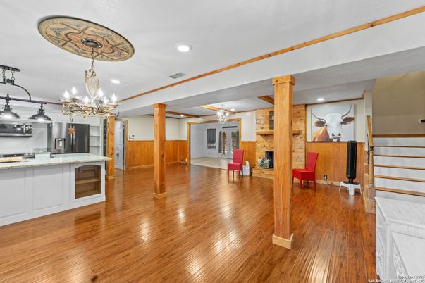 Chandelier, Fireplace, Interior, Kitchen, Recessed Lighting, Wood Texture Flooring, Wooden Walls