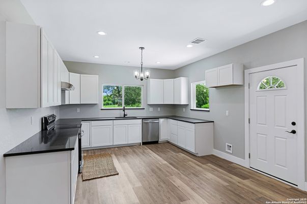 Chandelier, Interior, Kitchen, Pendant Lights, Recessed Lighting, Stainless Steel Appliances, Wood Texture Flooring