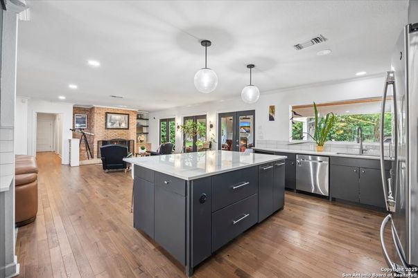 Fireplace, Interior, Kitchen, Pendant Lights, Recessed Lighting, Stainless Steel Appliances, Wood Texture Flooring