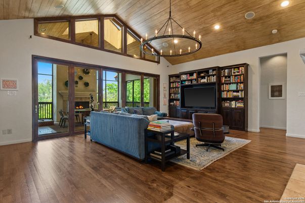 Chandelier, Fireplace, Interior, Living room, Pendant Lights, Recessed Lighting, Wooden Ceilings, Wood Texture Flooring