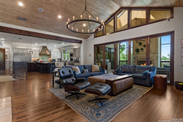Chandelier, Fireplace, Interior, Kitchen, Living room, Pendant Lights, Recessed Lighting, Stainless Steel Appliances, Wooden Ceilings, Wood Texture Flooring