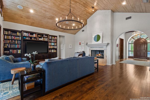 Chandelier, Fireplace, Interior, Living room, Pendant Lights, Recessed Lighting, Wooden Ceilings, Wood Texture Flooring