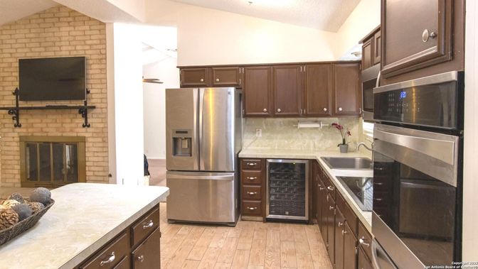 Fireplace, Interior, Kitchen, Stainless Steel Appliances, Stone Walls, Wood Texture Flooring