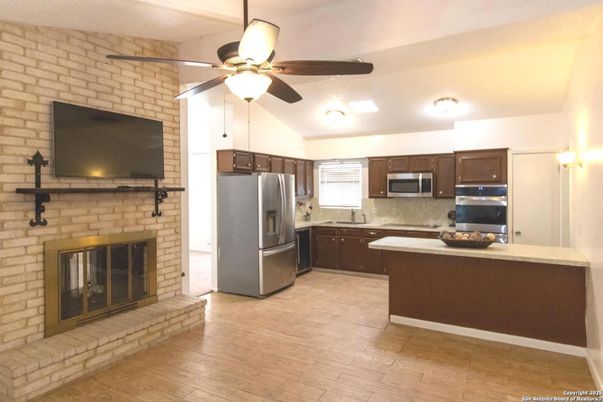 Fireplace, Interior, Kitchen, Stainless Steel Appliances, Stone Walls, Wood Texture Flooring