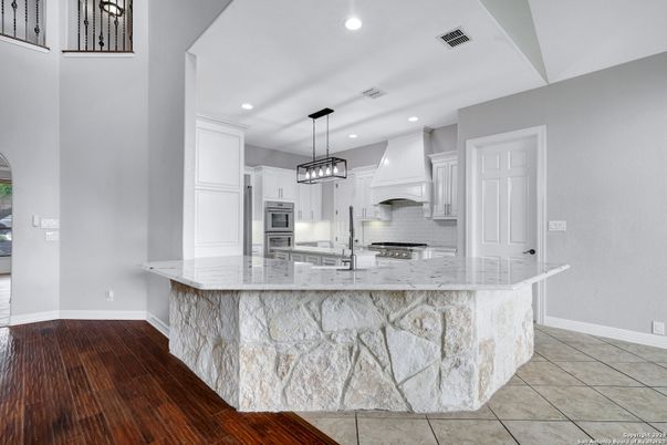 Interior, Kitchen, Marble Walls, Pendant Lights, Recessed Lighting, Stainless Steel Appliances, Wood Texture Flooring