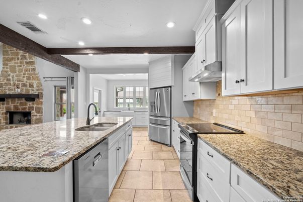 Fireplace, Interior, Kitchen, Recessed Lighting, Stainless Steel Appliances, Stone Walls
