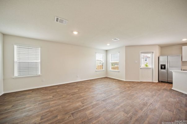 Empty room, Interior, Kitchen, Recessed Lighting, Stainless Steel Appliances, Wood Texture Flooring