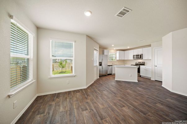 Empty room, Interior, Kitchen, Recessed Lighting, Stainless Steel Appliances, Wood Texture Flooring