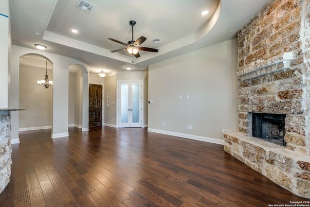 Chandelier, Empty room, Fireplace, Interior, Recessed Lighting, Stone Walls, Wood Texture Flooring