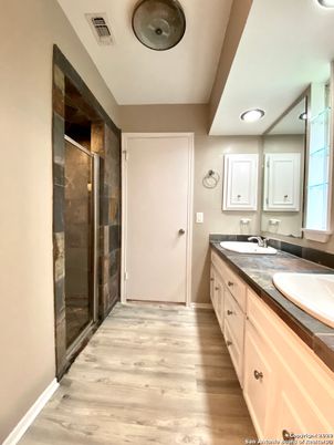 Bathroom, Dual Sink Vanities, Glass Shower, Interior, Recessed Lighting, Tile Countertops, Wood Texture Flooring