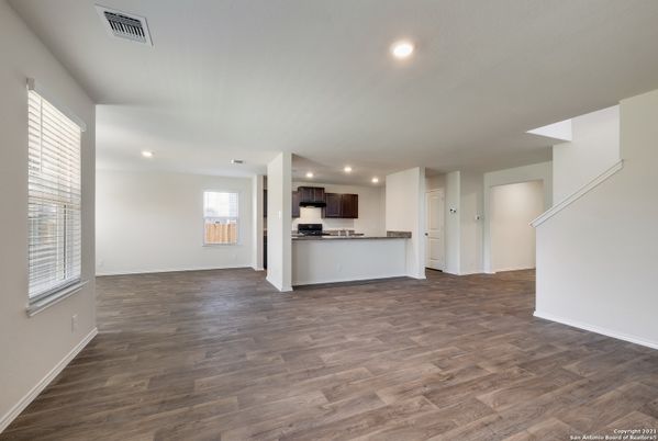 Empty room, Interior, Kitchen, Recessed Lighting, Stainless Steel Appliances, Wood Texture Flooring