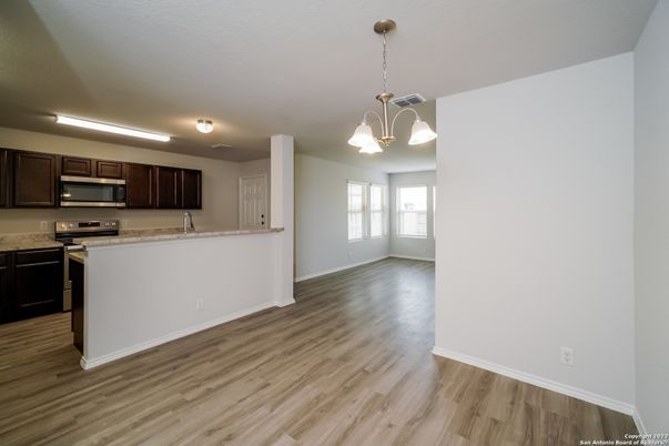 Empty room, Interior, Kitchen, Pendant Lights, Stainless Steel Appliances, Wood Texture Flooring
