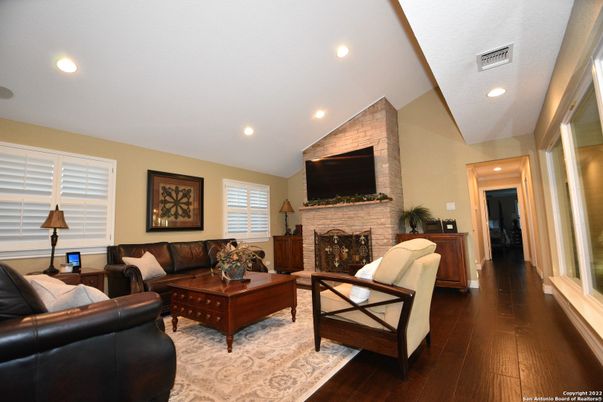 Fireplace, Interior, Living room, Recessed Lighting, Stone Walls, Wood Texture Flooring