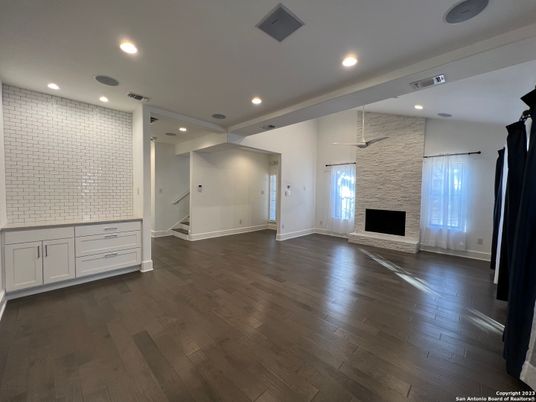 Empty room, Fireplace, Interior, Recessed Lighting, Stone Walls, Wood Texture Flooring