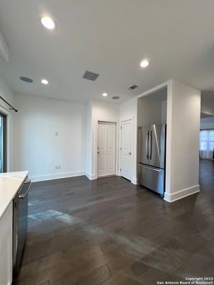 Empty room, Interior, Kitchen, Recessed Lighting, Stainless Steel Appliances, Wood Texture Flooring