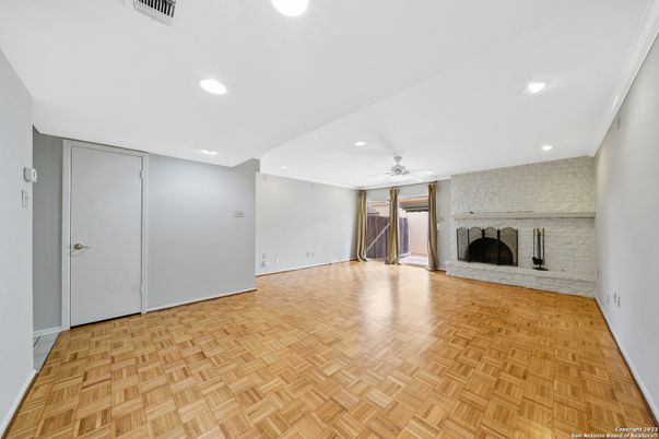 Empty room, Fireplace, Interior, Recessed Lighting, Stone Walls, Wood Texture Flooring