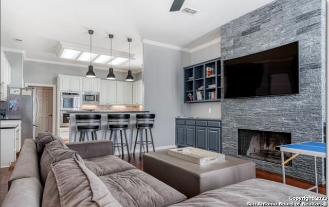 Fireplace, Interior, Kitchen, Living room, Pendant Lights, Stainless Steel Appliances, Stone Walls, Wood Texture Flooring