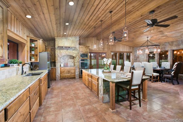 Chandelier, Dining room, Fireplace, Interior, Kitchen, Pendant Lights, Recessed Lighting, Stainless Steel Appliances, Wooden Ceilings