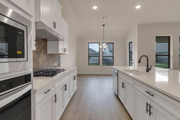 Chandelier, Interior, Kitchen, Pendant Lights, Recessed Lighting, Stainless Steel Appliances, Wood Texture Flooring