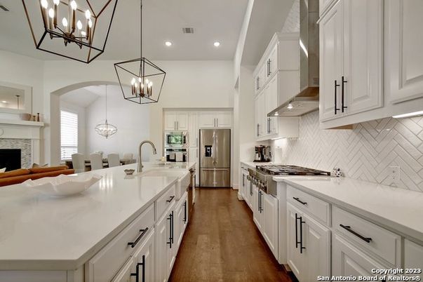 Chandelier, Fireplace, Interior, Kitchen, Pendant Lights, Recessed Lighting, Stainless Steel Appliances, Wood Texture Flooring
